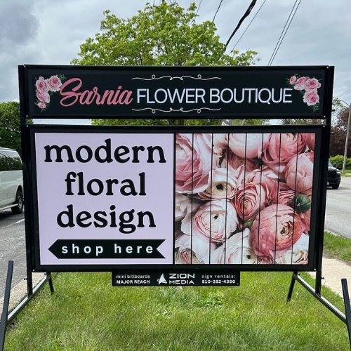 Road sign for flower shop in Corunna
